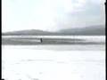 Kneeboarding over open water behind a Snowmobile