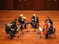 the chamber group, formed by sir neville mariner, performing in oxford at the ford center on the campus of ole miss.

the academy has an illustrious recording career, best exemplified by their performances on the film soundtracks for titanic, the english patient, and amadeus.  they have more recorded sessions (500+) than any other chamber group.

this clip contains the final few bars of the allegro moderato-allegro con brio movement from dvo?�k's sextet for strings in a major, op. 48.

unfortunately, the clapping spoils the delicate decrescendo that precedes the interlude between movements.

for the uninitiated (who obviously paid a great deal to see a chamber group of this caliber), the space between movements is a deliberate silence in the music.  except for some extraordinary circumstances the audience should refrain from ruining the effect with clapping.