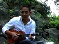 man playing the ukelele.