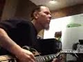 Robert Trujillo playing an acouistic guitar