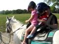 Katie and Tommy riding on a horse