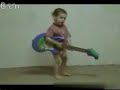 A 2years old boy plays juitar