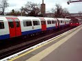 Two Piccadilly line tube trains arrive at Osterley station
