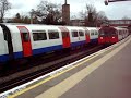 Two Piccadilly line tube trains arrive at Osterley station