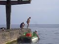 Big-bellied man jump in a water