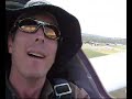 Hang glider pilot tries out sit-in type gliding.