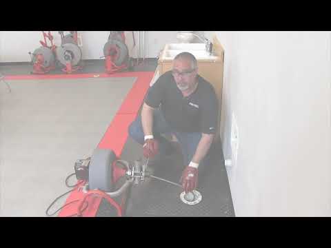 Using the RIDGID K3800 drum machine to clean a floor drain