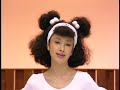 A poodle woman leading a bunch of lyotard-clad poodles as she takes them through their paces. think olivia newton john's let's get physical meets crufts