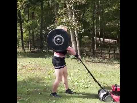 Guy Carrying 500Pound Barbell On Shoulders While Mowing The