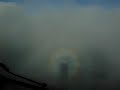 Dcending through clouds with airplane shadow