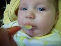 Morganne is captured here getting a taste of babyfood/applesauce.  Num, nums!