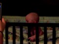 Miko trying to get out of crib