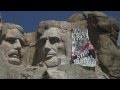 Greenpeace climbers hung a banner on Mount Rushmore challenging President Obama to show real leadership on global warming. The banner, measuring sixty-five feet high by thirty-five feet wide, features an unfinished portrait of Obama with the message,