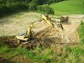Kobelco SK 200 excavator load trucks