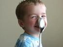 Baby balances a spoon on his nose.