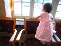 Clarice is walking across chairs