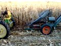 John Deere A tractor pulling a New Idea corn picker picking