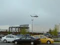 Helicopter lifting an air conditioning unit.