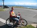 Beth riding her wheelchair hand-cycle