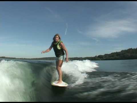 Debbie riding Infectious board