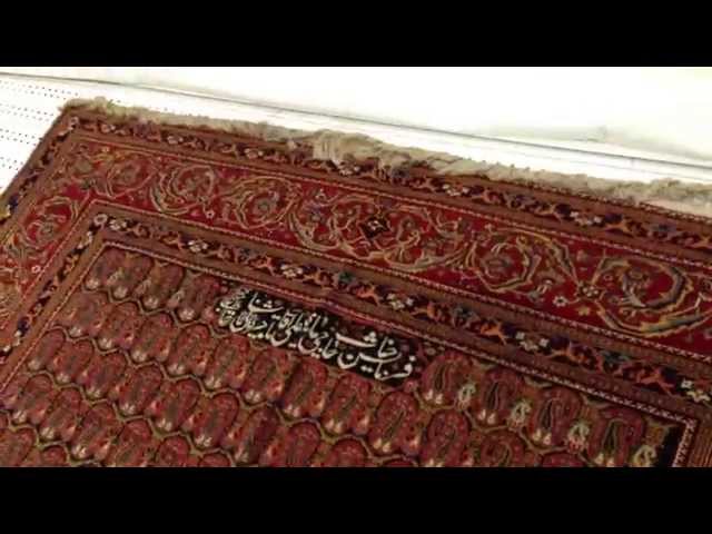 Mashhad Carpet Museum closed view of Mohtasham antique carpet in museum