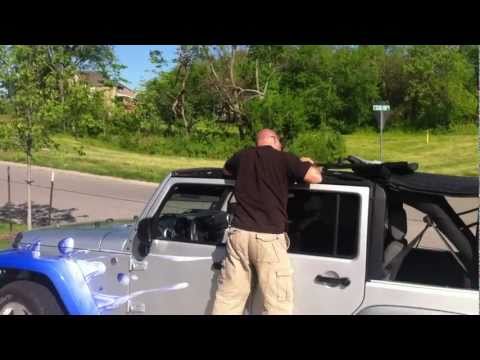 Putting up the soft top on four door Jeep Wrangler