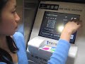 Hei recharging her subway card in Taipei, Taiwan