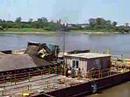 John Deere 724J unloading a barge