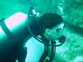 Two girls scuba dive The Amphitheatre, Paphos. Cyprus.