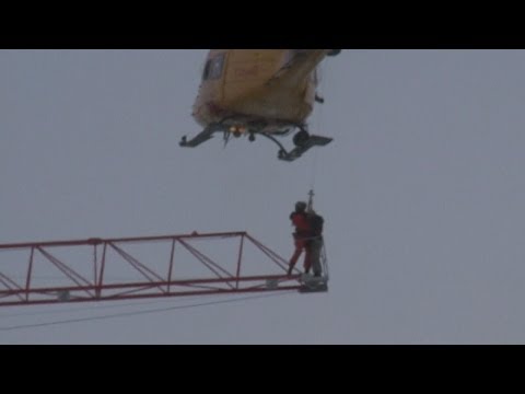 Helicopter plucks crane worker to safety high above fire in Canada