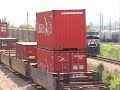 A CSX Intermodel blasts by while an NS Empty Coal Train slowly follows.