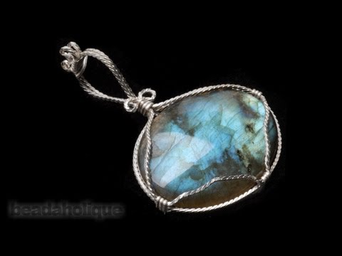 wrapped - http://www.beadaholique.com/yt - In this video, wire wrapping expert Wyatt White shows you how to create a stone setting to turn your favorite cabochon into ...