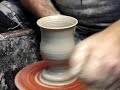Throwing a clay pottery goblet single handed quickly on a potters wheel demonstration