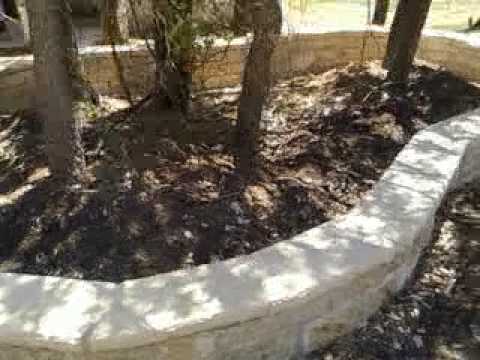 José Santos Masonry: Nicotene Chopped Limestone Flower Bed