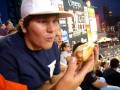 some gnarly kid scarfs down a hot dog