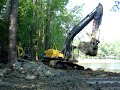 Excavator digging out a pond Excavator digging out a pond