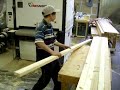 This is a Timesavers Model 1300 Double Head Sander.  It is used for accurately sanding material up to 36" wide.  In this operation the headposts recently cut on the straight line rip saw are being sanded to a 150 grit finish.  The material is fed into the conveyor and automatically sanded by two sanding heads. After passing through the machine it is inspected and stacked for the next operation.