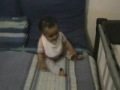 Funny cool baby trying to stand