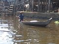 Child sailing a boat in Cambodia. Floating town near Siem Reap.