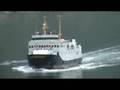 QE2 passes ferry in Geiranger Fjord