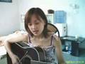 A girl is singing a sog bt guita