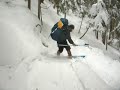 heavy pack and long ski out causes crash on steep switchback.