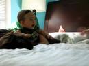 G2 laughing on bed - 8.5 months