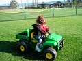 Toddlers riding their John Deere Gator Power Wheels