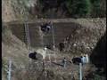 Embankment for rock fall protection with geogrid in HDPE