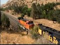 Two manifest trains climbing toward the Tehachapi Loop