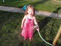 14 month old Elsie drinking from the hose in the yard with the dogs.