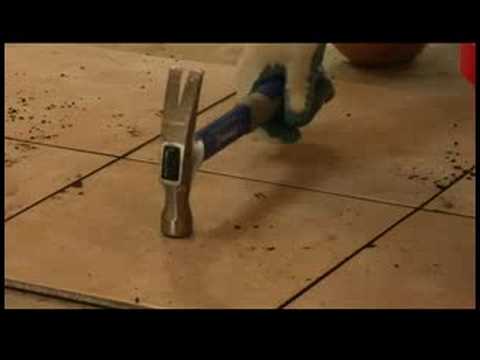 tiles - Replace cracked tile floor tiles using a grout scraper, pry bar, hammer and safety glasses. Learn how to replace cracked floor tile using the home repair tip...