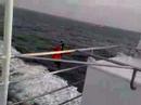 A coast guarding lands on ferry from helicopter