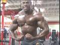 Bodybuilder Kevin Sperling curls, posing